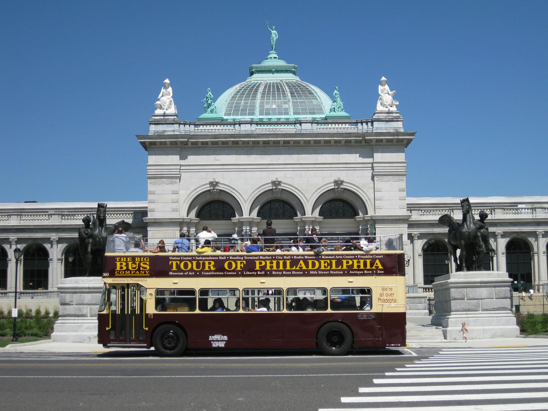 An open-top tour bus labeled 