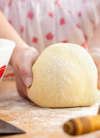 kneading bread dough on the counter by hand