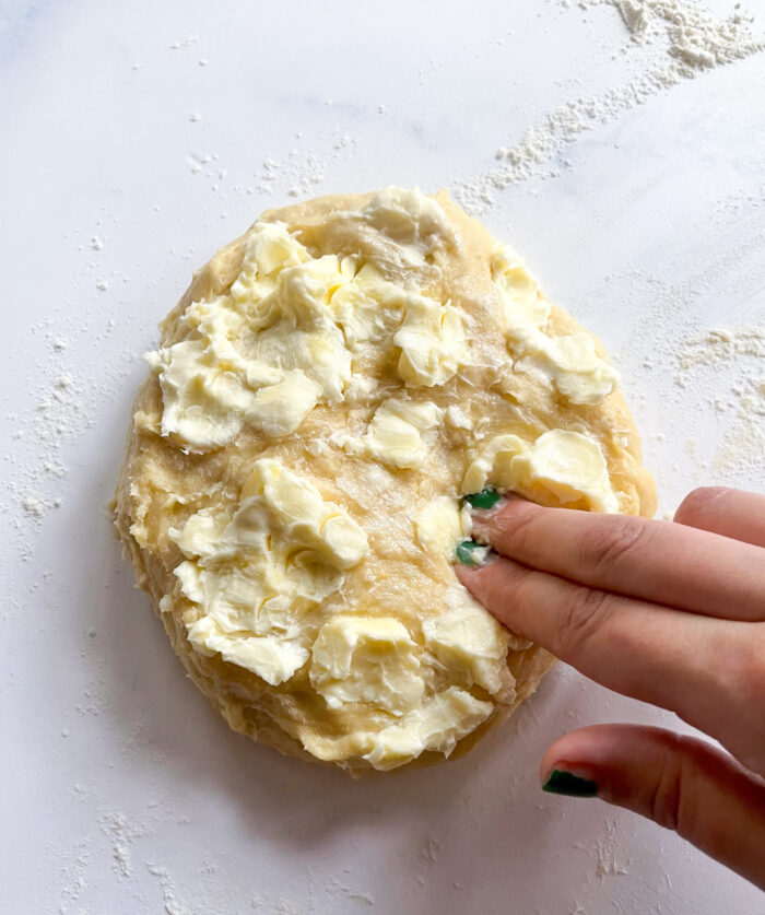 dimpling soft butter into the dough