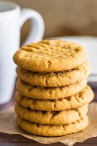 Stack of small-batch peanut butter cookies on parchment paper.