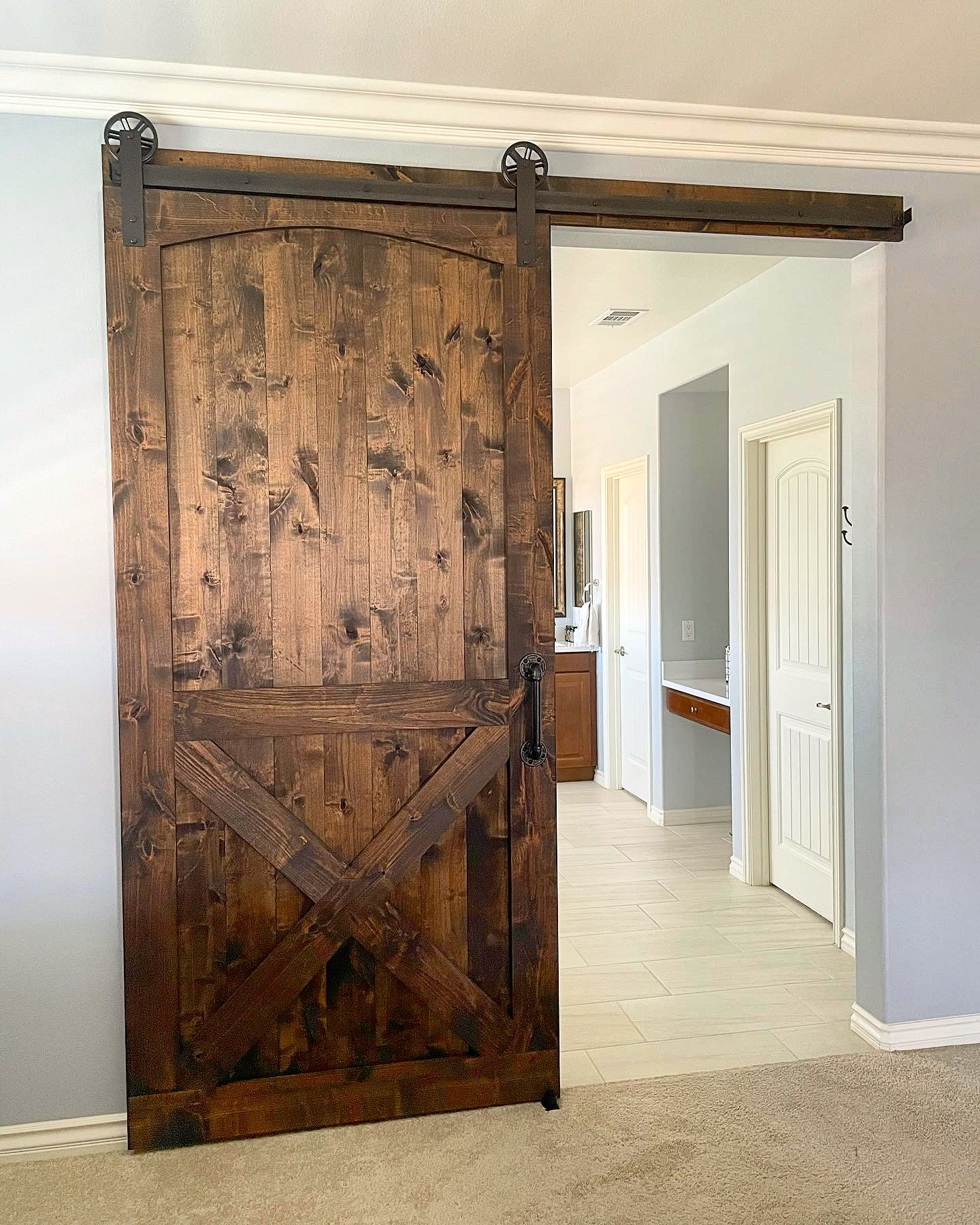 Knotty Alder Arched Bottom X Brace Barn Door with Our Traditional