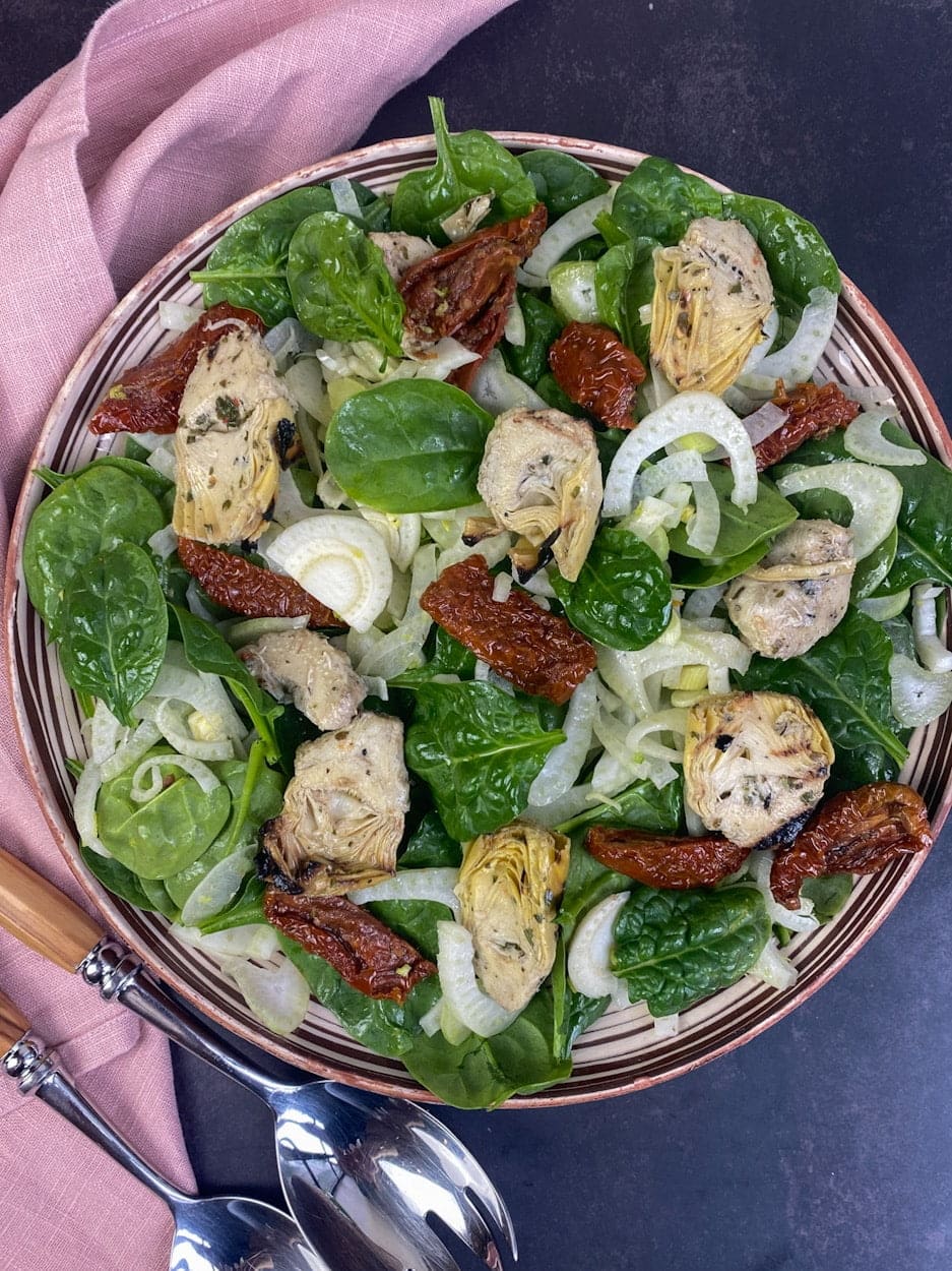 Spinach and fennel salad with sun dried tomatoes and charred artichokes