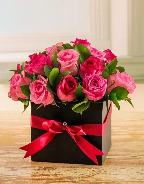 Elegant pink roses in a box.