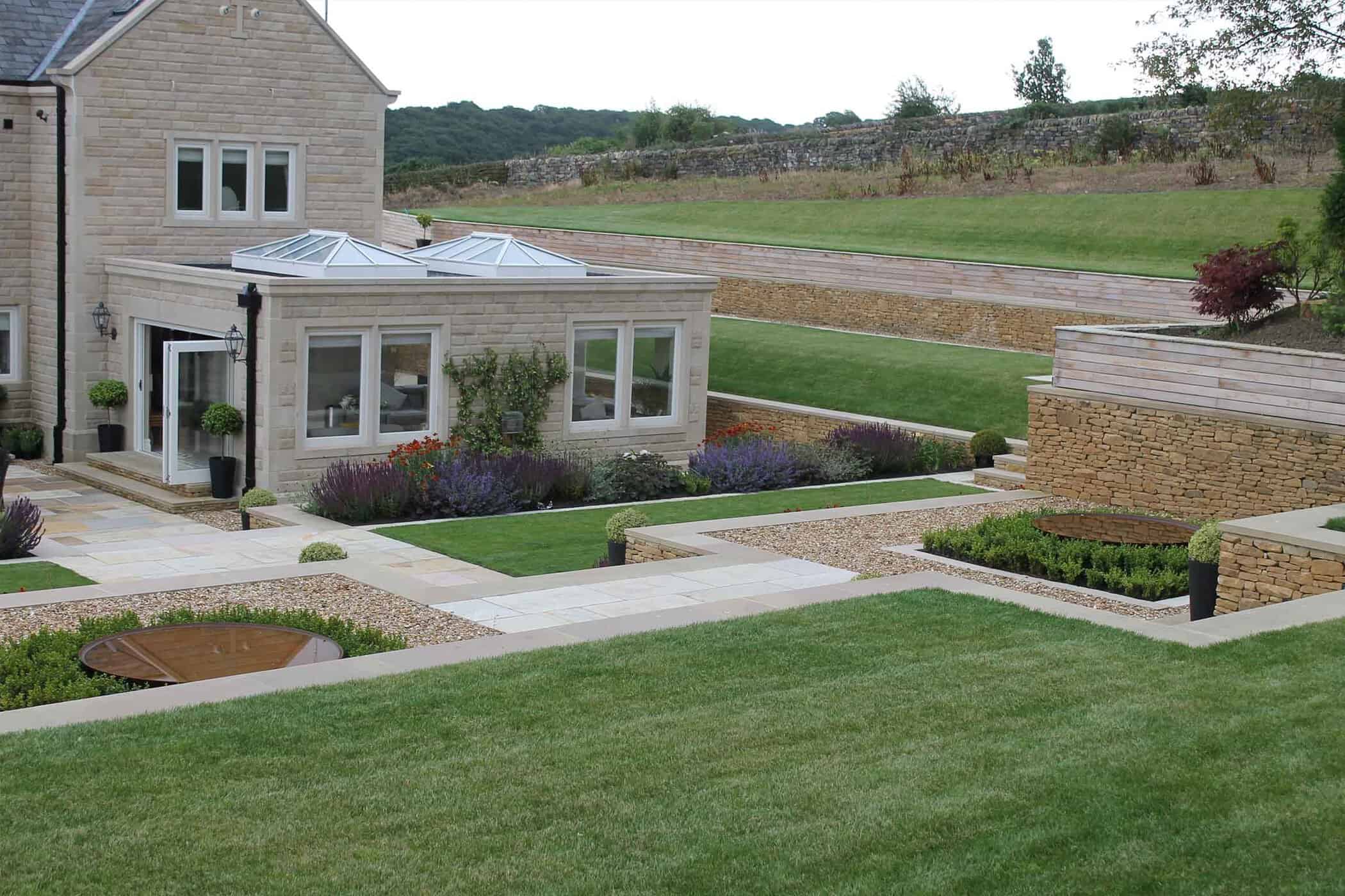 Modern terraced garden with level lawns and colourful planting
