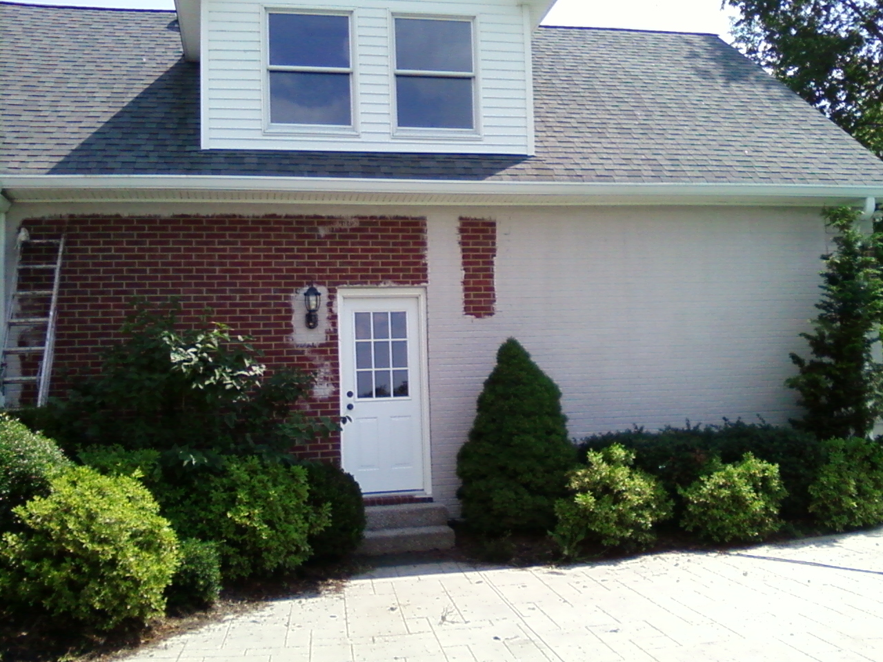 A Front Porch Renovation with Columns and a Herringbone Brick Floor