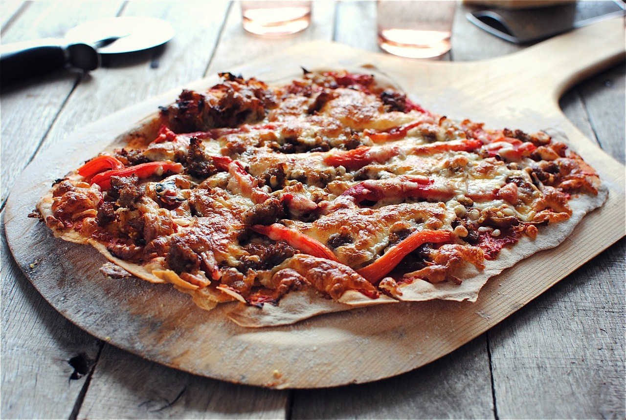 Thin Crust Pizza with Caramelized Onions, Sausage and Roasted Red