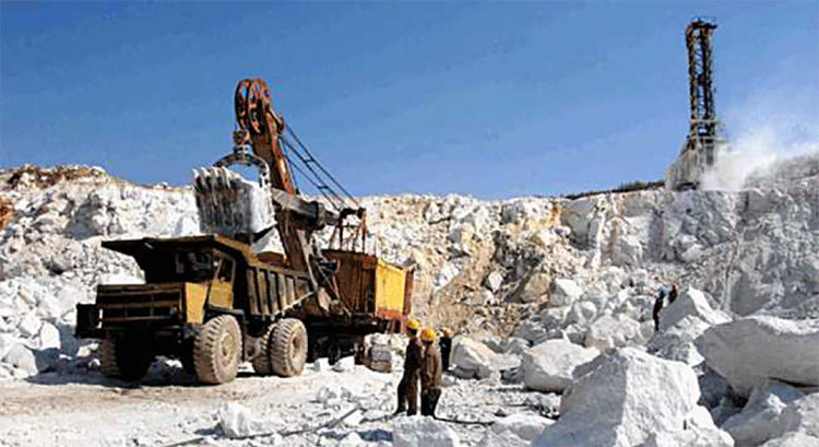 A large ore haul truck being loaded by shovels at the Taehung Youth Hero Mine. (Naenara, April 12, 2013)