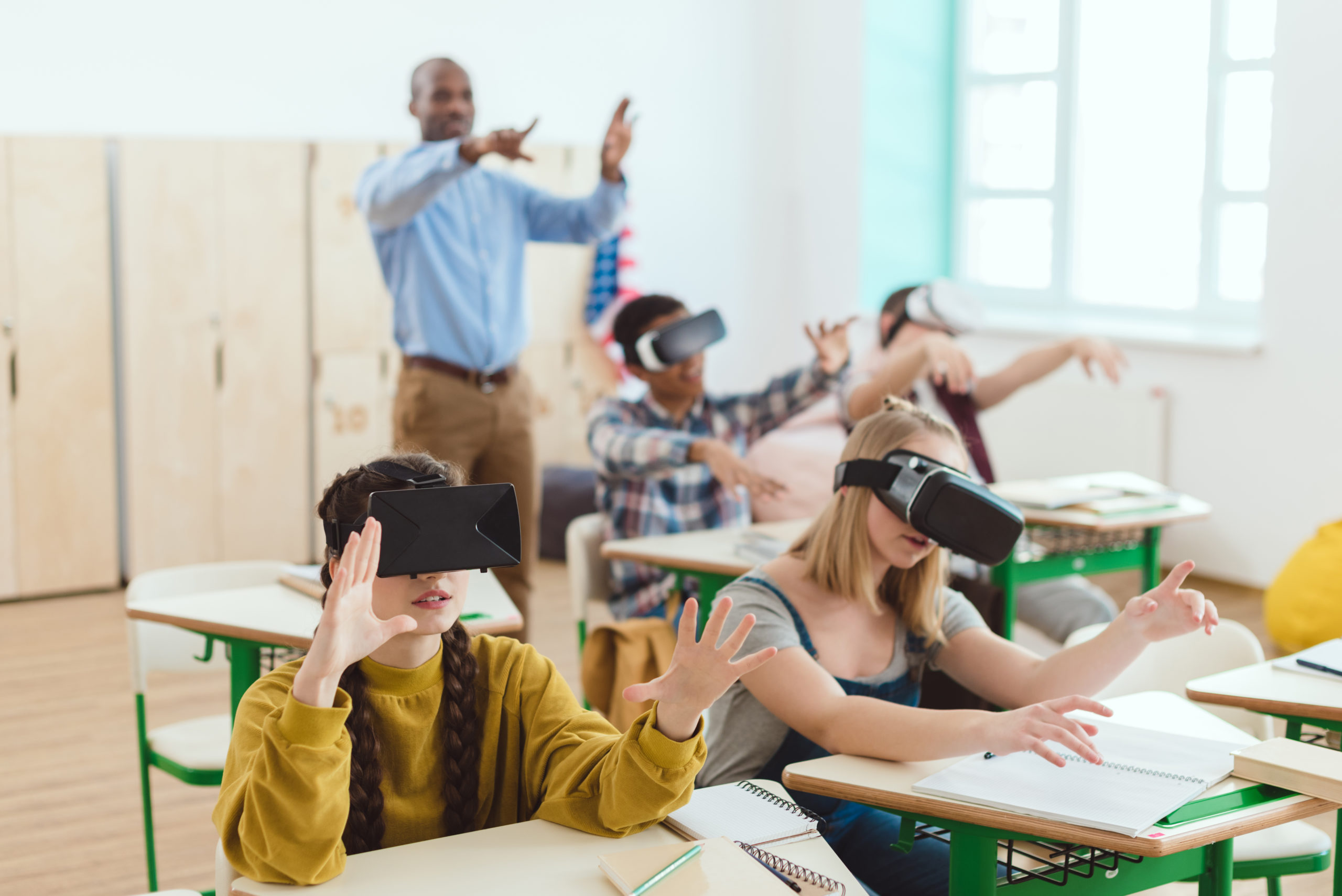 High school teenage students using virtual reality headsets and