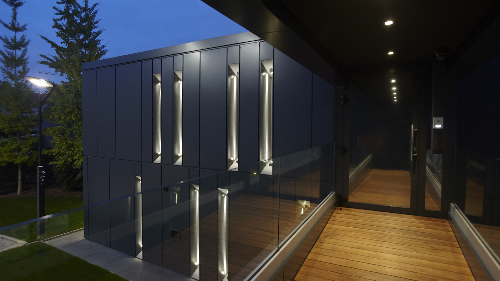 Illuminating the fortified openings that wrap around the buildings