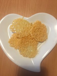 baked cheese crisps on a heart shaped plate