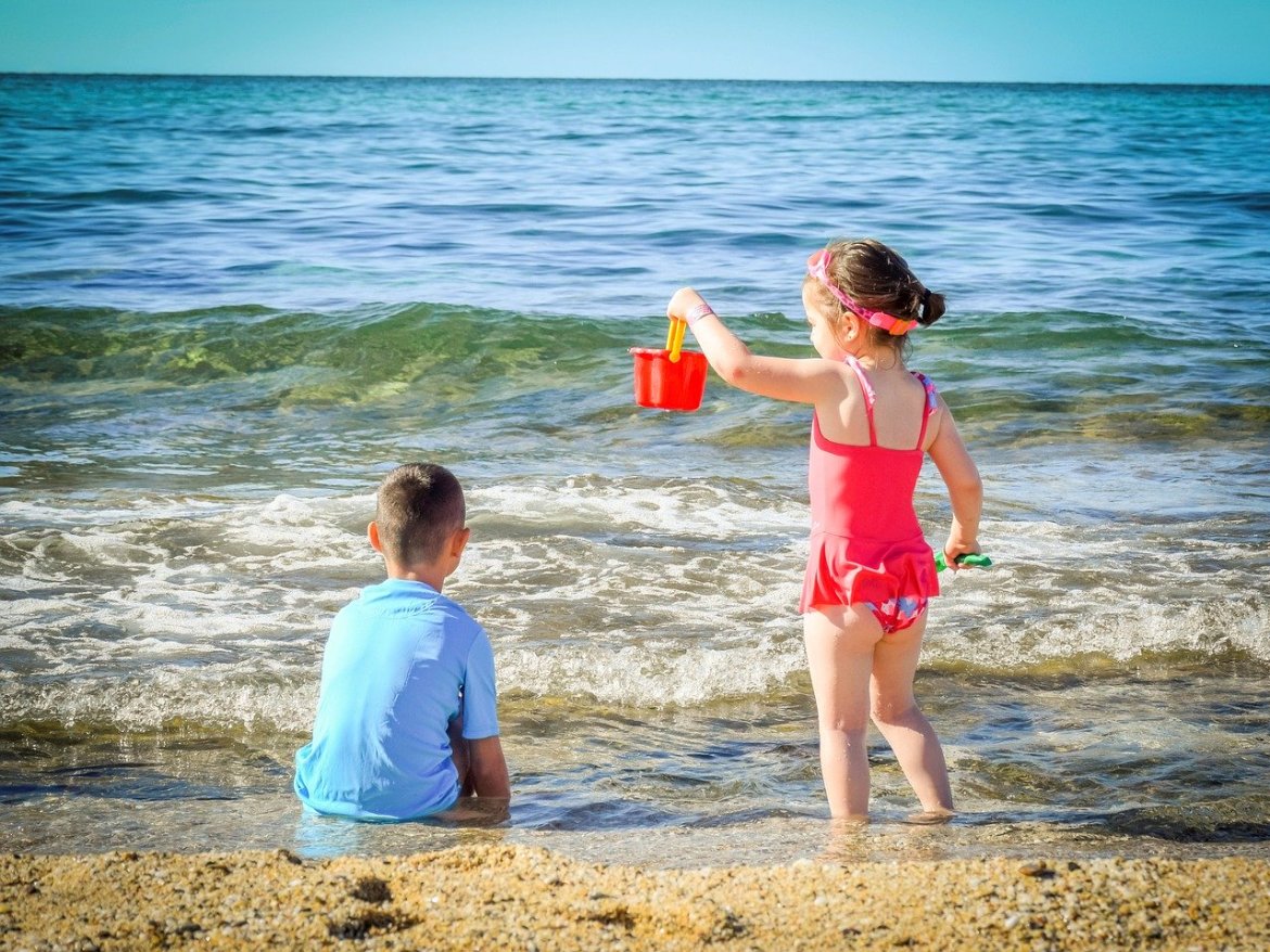 kids playing at the beach on holidays