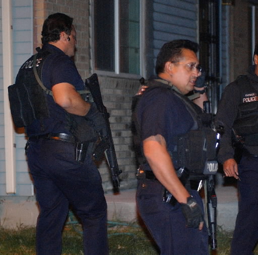 Denver police SWAT team search the area near Falcon Park for suspects in shooting Cold Cases