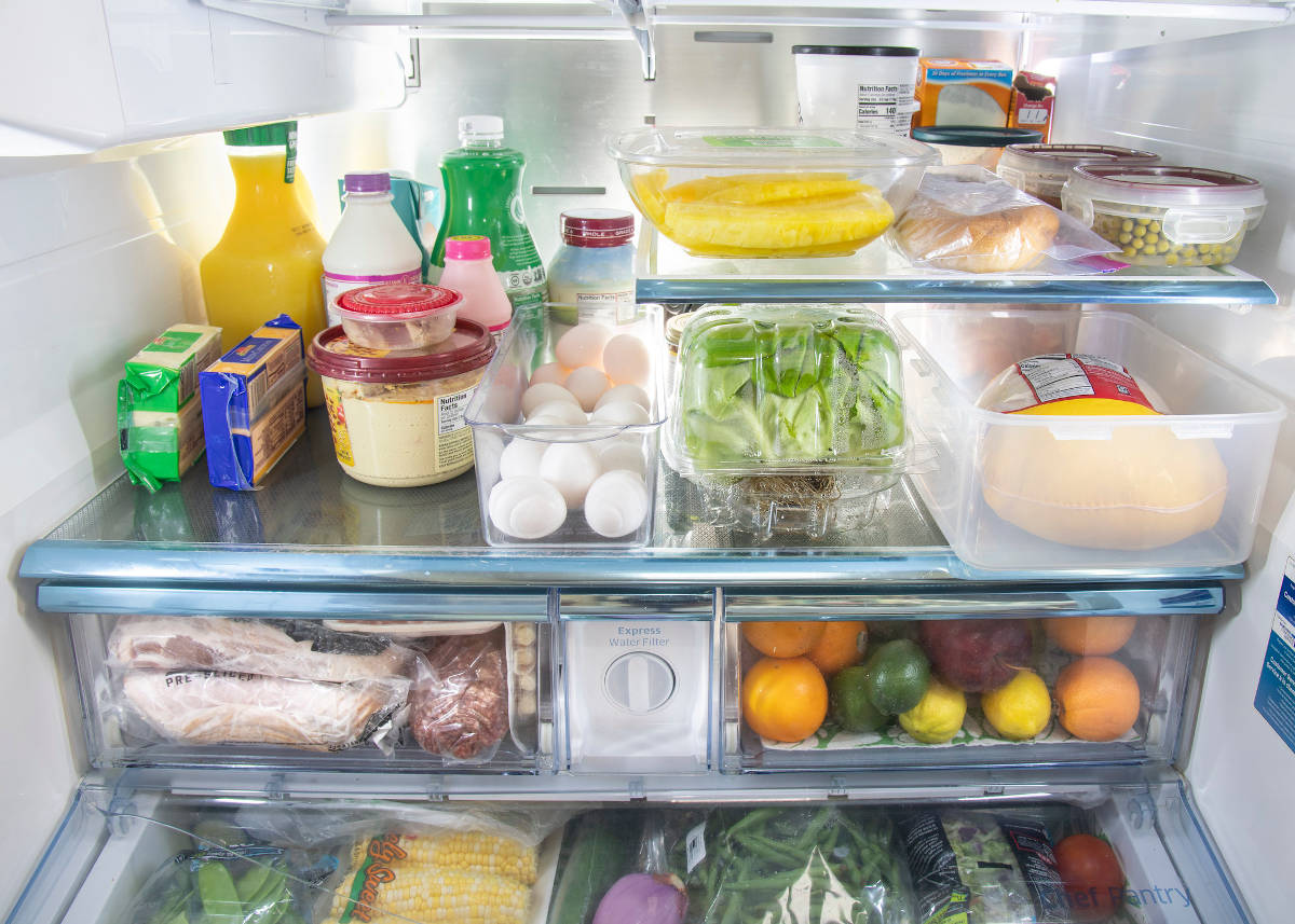 Photo of open fridge filled with food