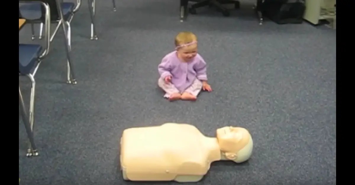 Baby Demonstrates CPR On Dummy