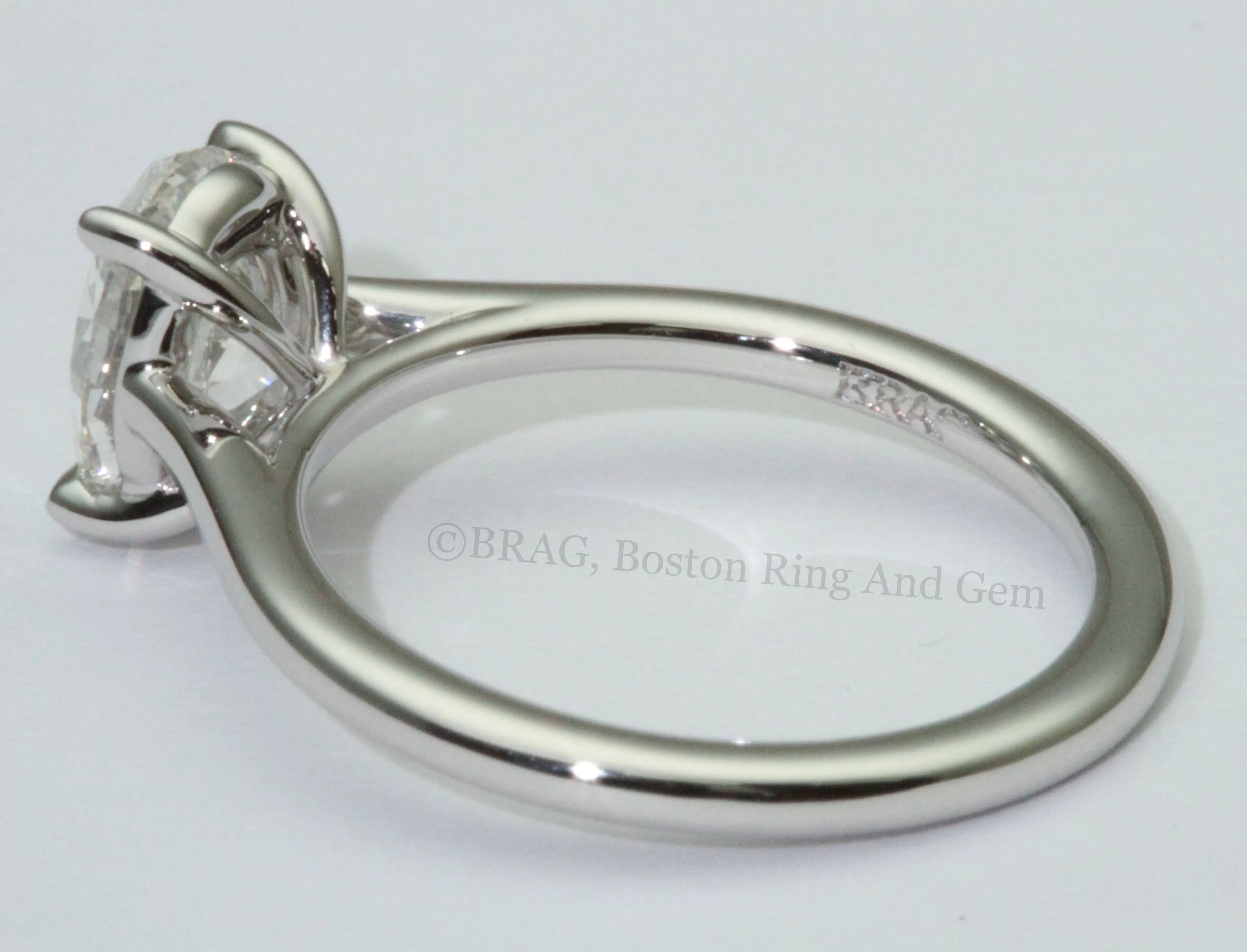 Oval cut diamond set in thin platinum cathedral Solitaire Engagement