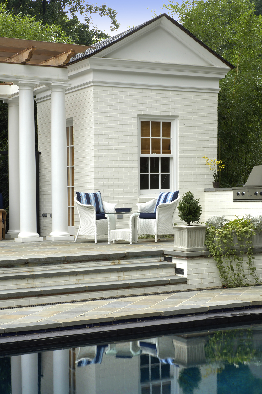 Pool House Addition on Raised Terrace Creates Stunning Outdoor Space in