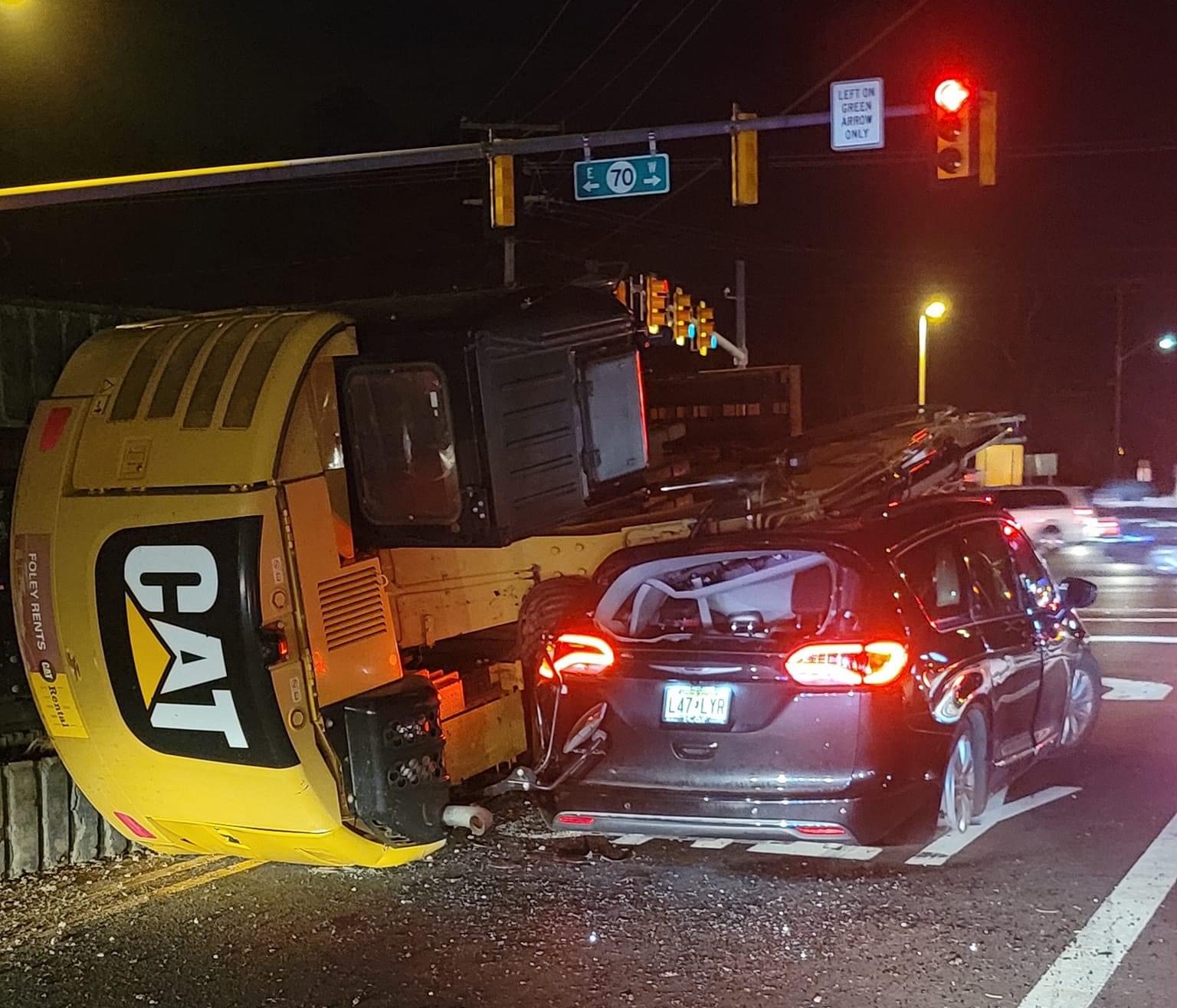 Truck Towing Excavator Takes Out Poles in Brick, Then Overturns Onto Car in Toms River Brick