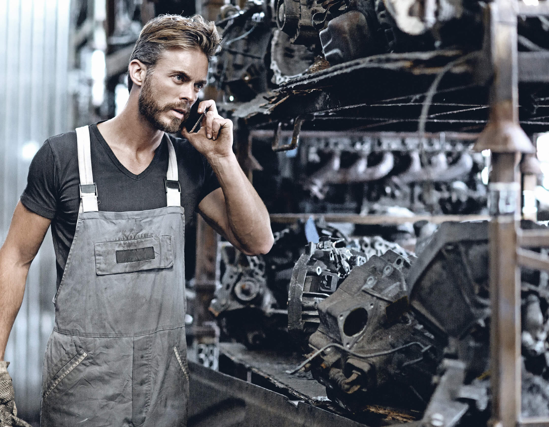 male mechanic working at junkyard storage Blue Streak