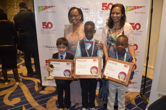 ( Front row L - R) Winner of the children's competititon Ali Jamee Mohammed of Kiota School , First runner up Allan Mogori Karioko of whitestar springs and Leonel Ngatia of Kiota Schools who was the second runner up. (  Back row  L- R) PS Aidah Munano, Arch. Emma Miloyo