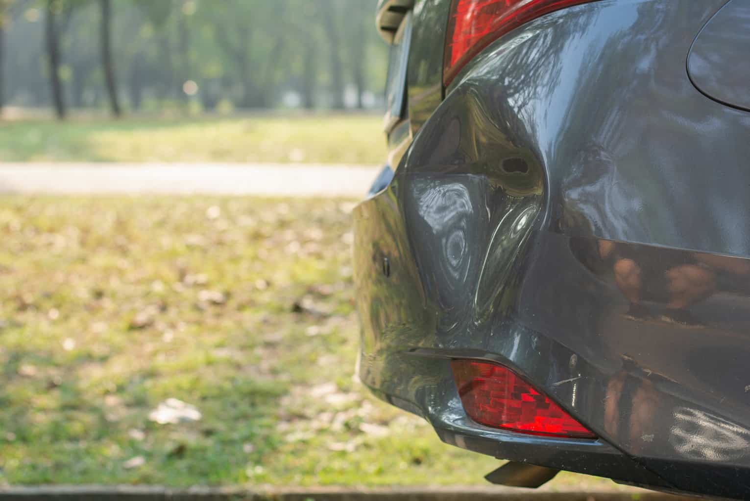 Car a broken rear bumper, The car stopped on road which has damage or
