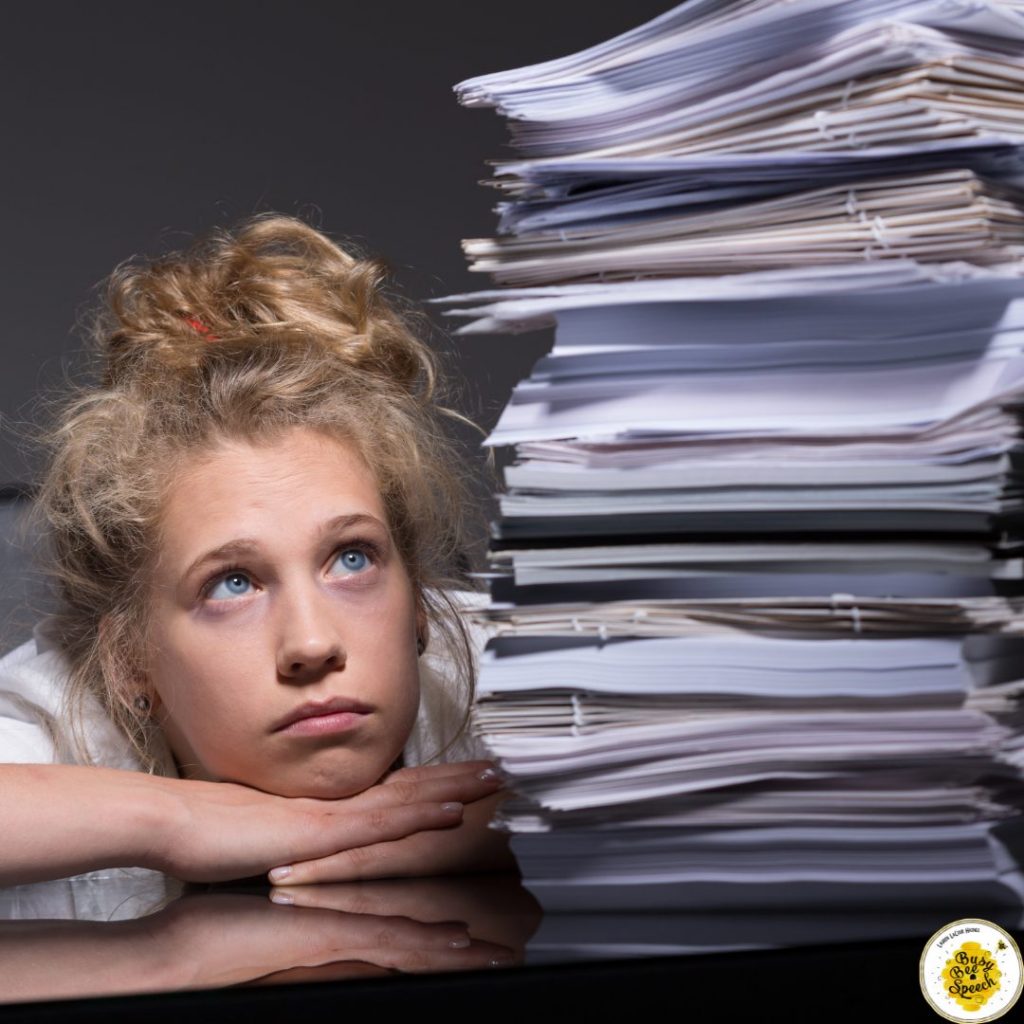 girl staring at a stack of paperwork