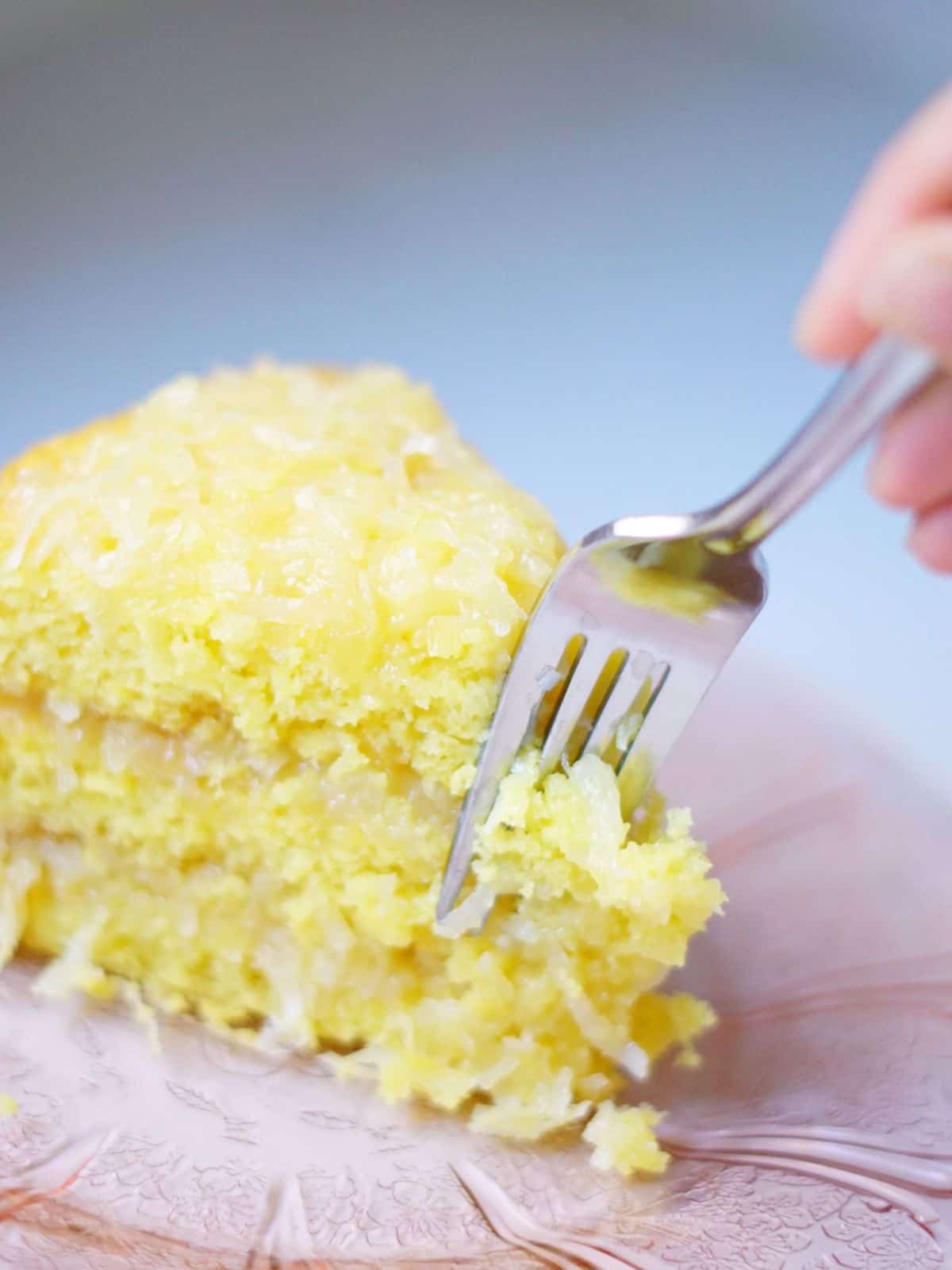 someone taking a bite of 7 up cake