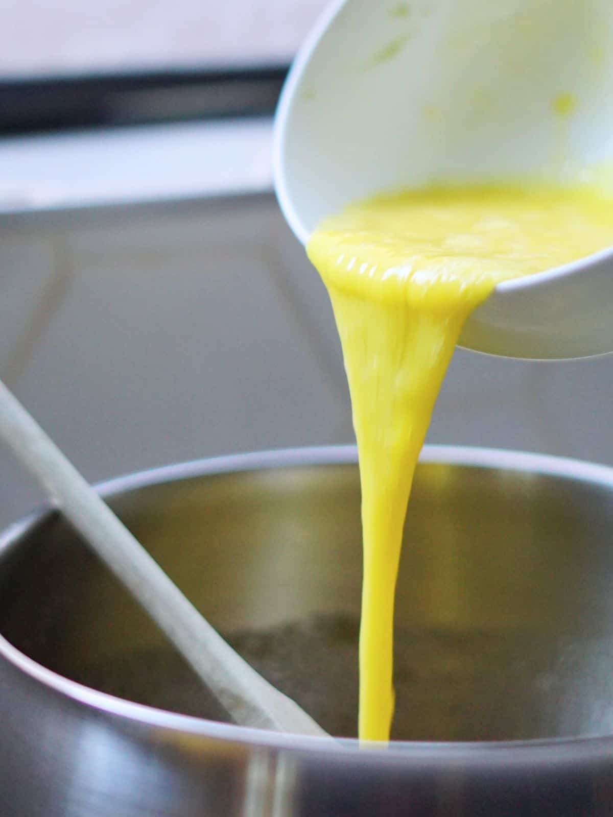 eggs being poured into a pot