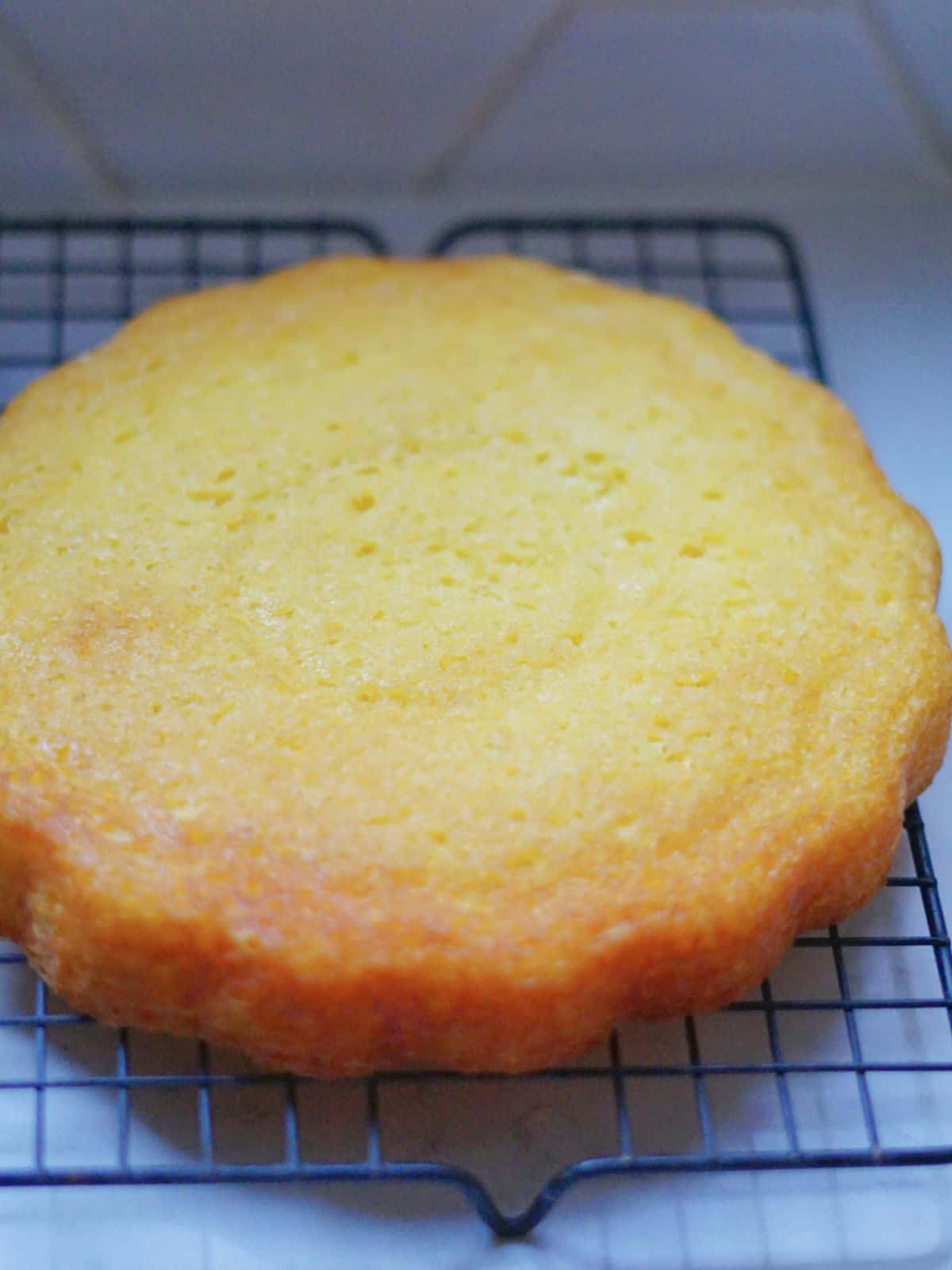 one layer of 7 up cake cooling on a rack