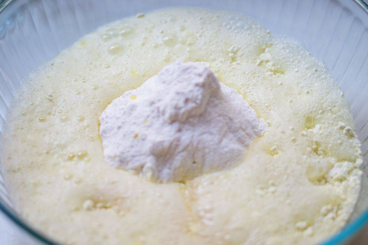 liquid ingredients being added to dry 7 up cake batter
