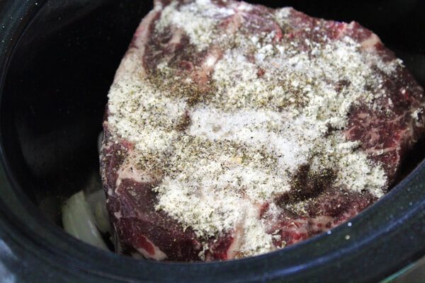 Red Wine Slow Cooker Roast with baby potatoes, onions and pickled peppers. This recipe has an Italian feel to it, and is still an All-American hearty meal.