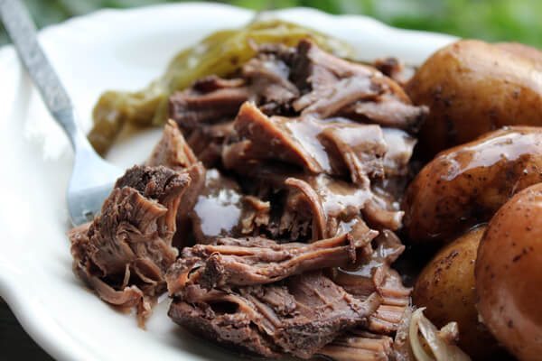 Red Wine Slow Cooker Roast with baby potatoes, onions and pickled peppers. This recipe has an Italian feel to it, and is still an All-American hearty meal.