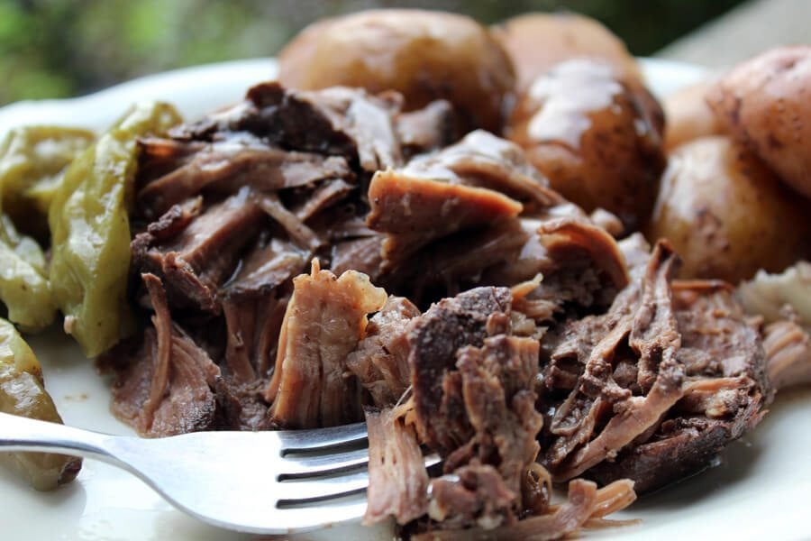 Red Wine Slow Cooker Roast with baby potatoes, onions and pickled peppers. This recipe has an Italian feel to it, and is still an All-American hearty meal.