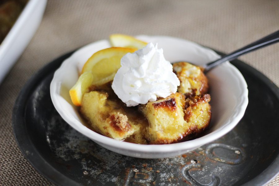 Spiced Rum + Orange Bread Pudding A vintage white bowl filled with orange + rum flavored bread pudding