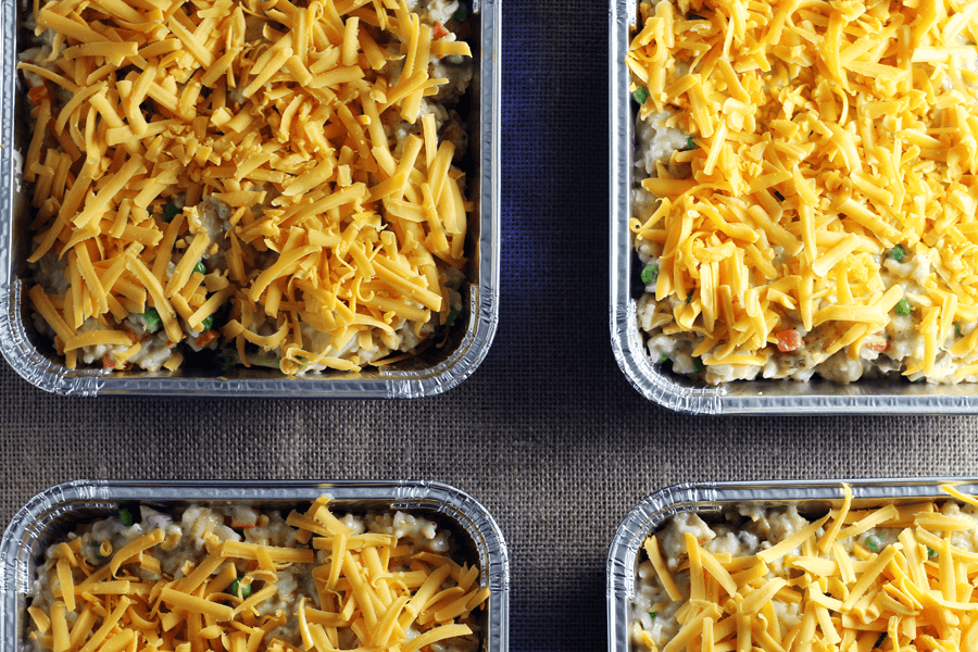 This chicken rice casserole is easy to make ahead for fast weeknight dinner. A shot of four casserole dishes with chicken rice casserole and cheesy topping