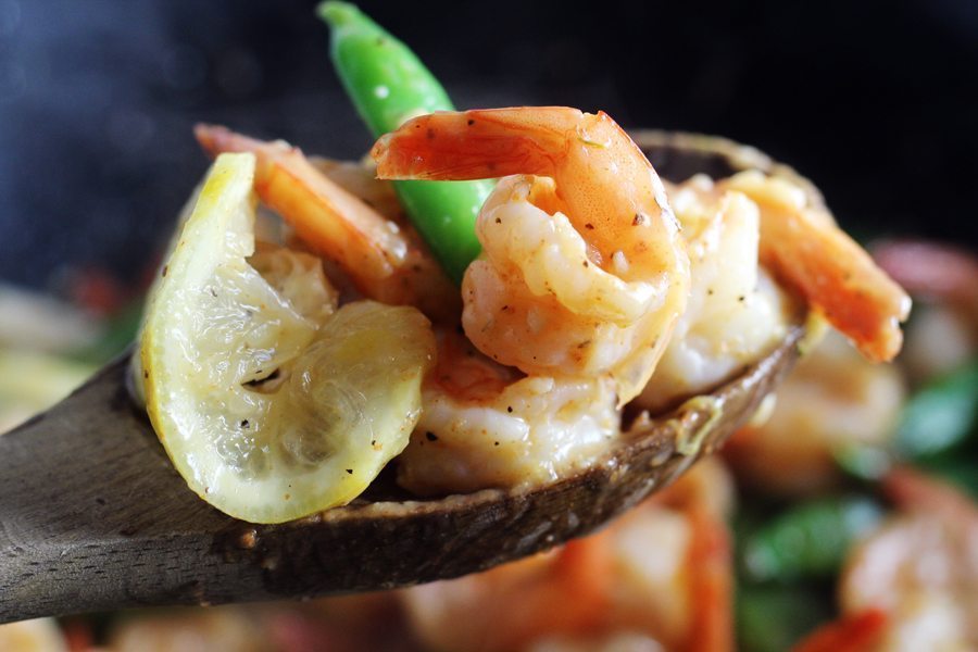There is flavor in every single bite of our Lemon Garlic Shrimp. A wooden spoon with garlic lemon shrimp