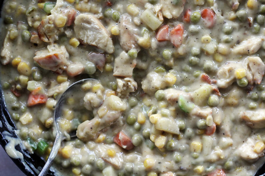 Mixed hearty vegetables and savory chicken are the key ingredients in the filling for this Homestyle Double Crust Chicken Pot Pie. Rich and thick filling for chicken pot pie.