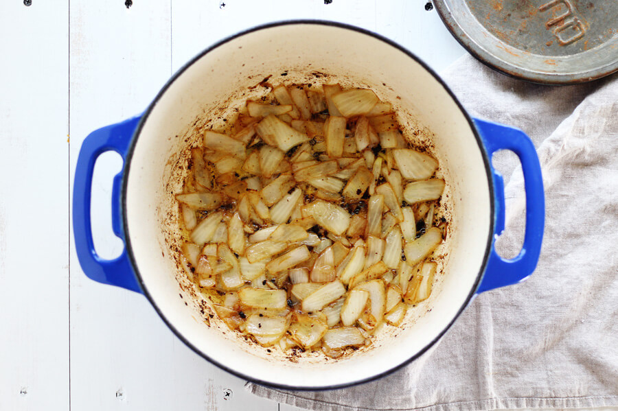 For depth of flavor, caramelize the onions before adding the other ingredients. Onions cooking in a large pot
