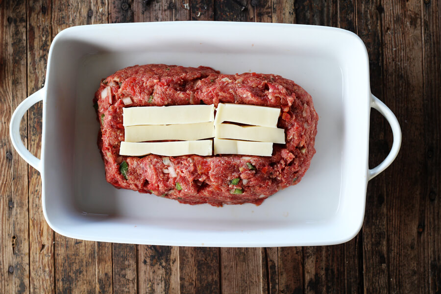 Meatloaf being stuffed with mozzarella cheese