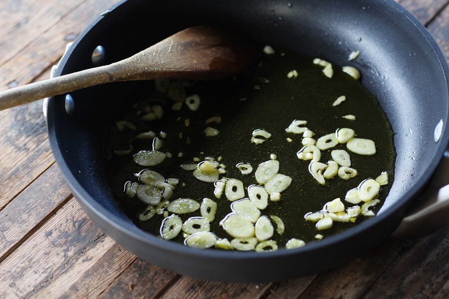 garlic simmering in a small skillet