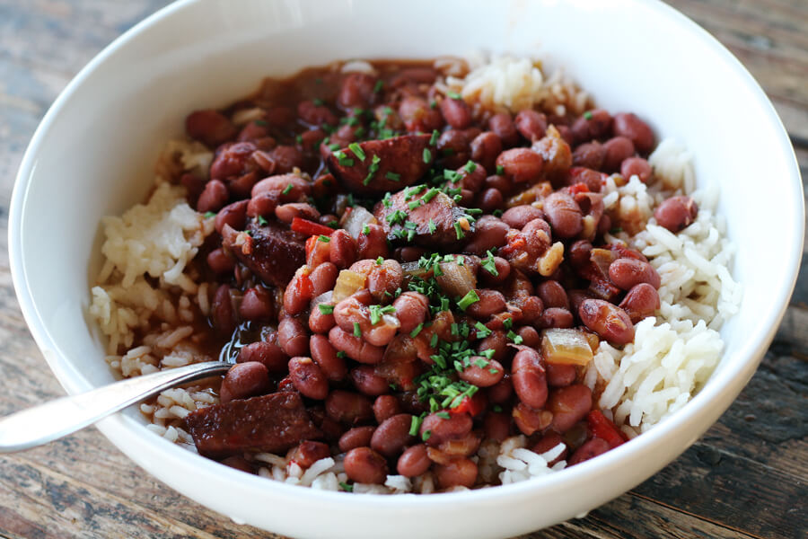 a white bowl with beans and rice