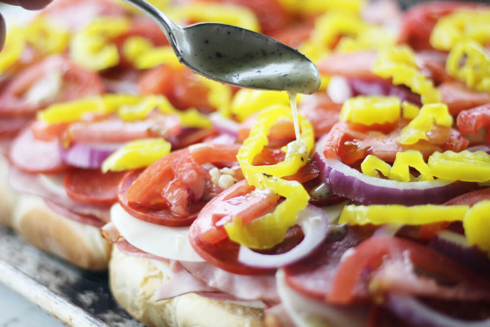 Italian dressing drizzled over the top of sliders