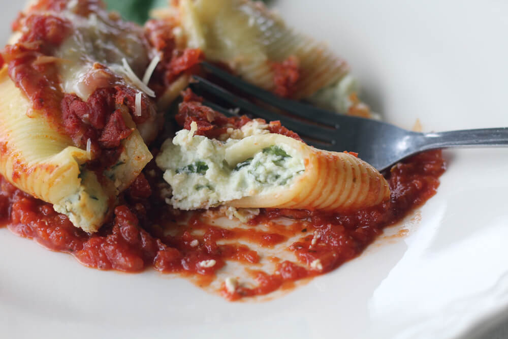 a white plate with pasta and sauce