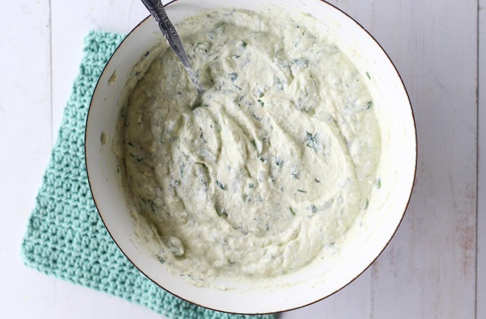 overhead picture of a ricotta and spinach filling in a white bowl