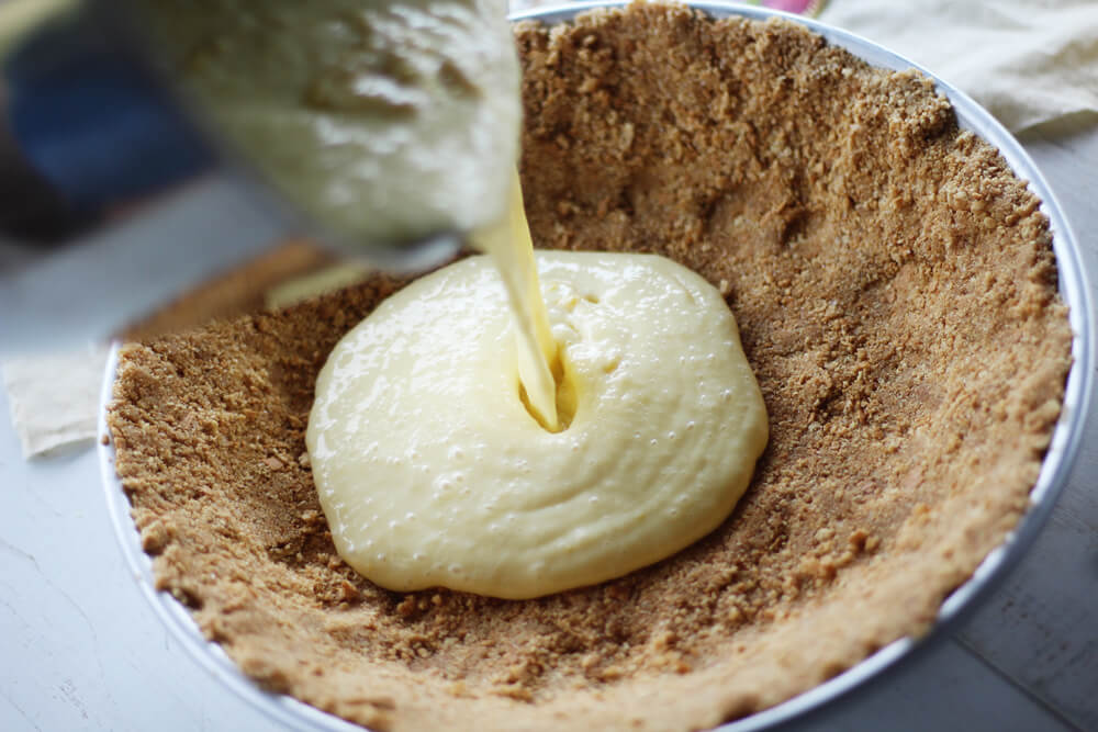 lemon pie filling poured into a graham cracker crust
