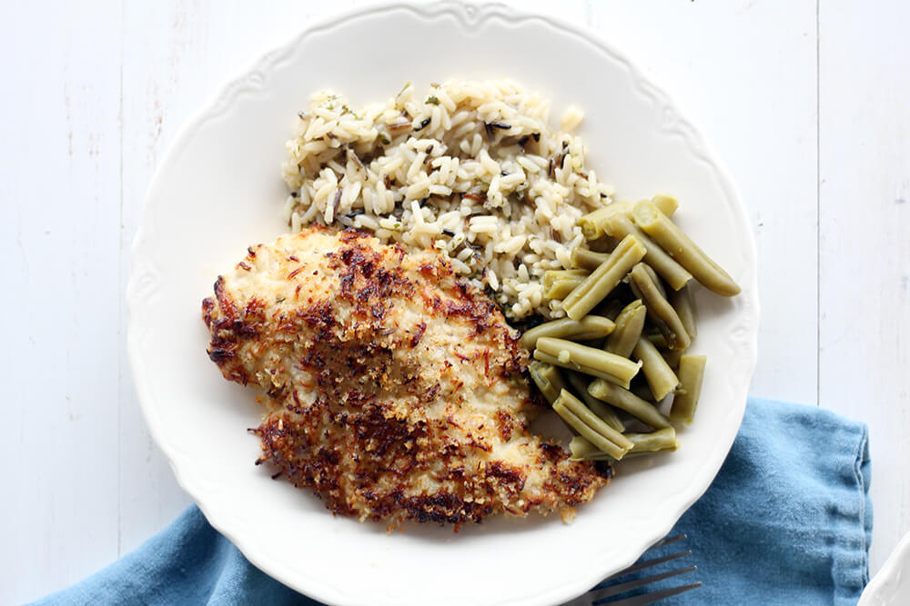 overhead picture of a dinner plate with chicken, rice, and vegetables