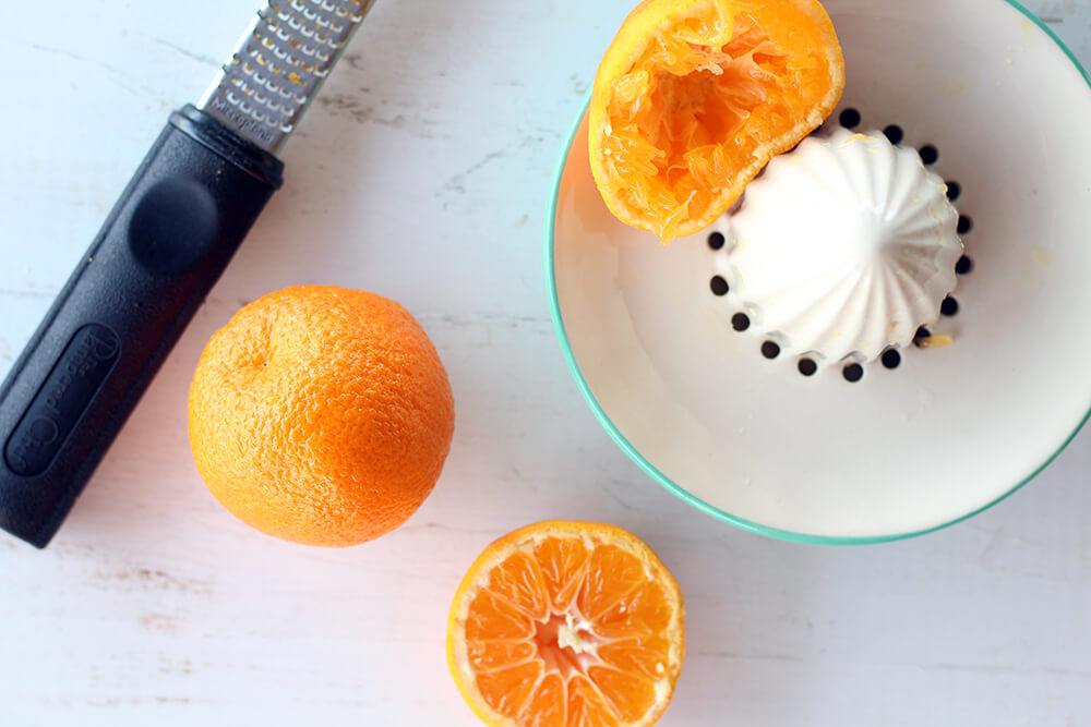 mandarin oranges being zested and juiced