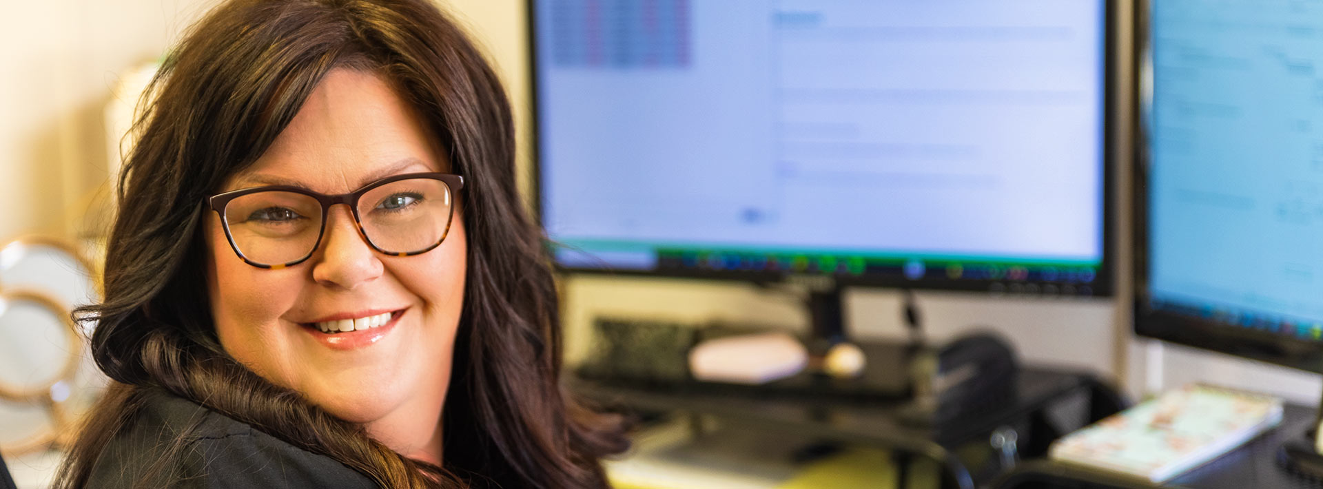 Lori works through a spreadsheet at her desk.