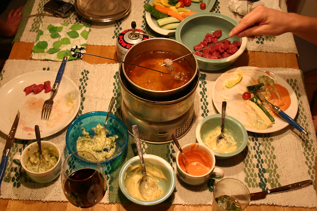 Fondue bourguignonne beef meat cooked in hot oil, dipped i… Flickr