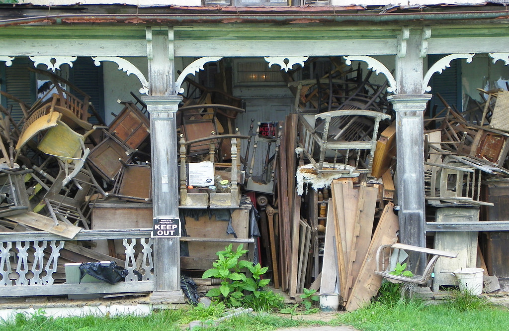 Front porch of a house piled full of junk Front porch of a… Flickr