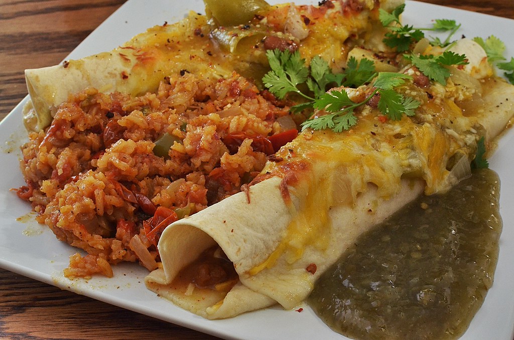 Mmm... chicken enchiladas with Spanish rice jeffreyw Flickr